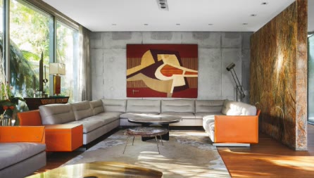 Formiture — A living room with an orange armchair and stone