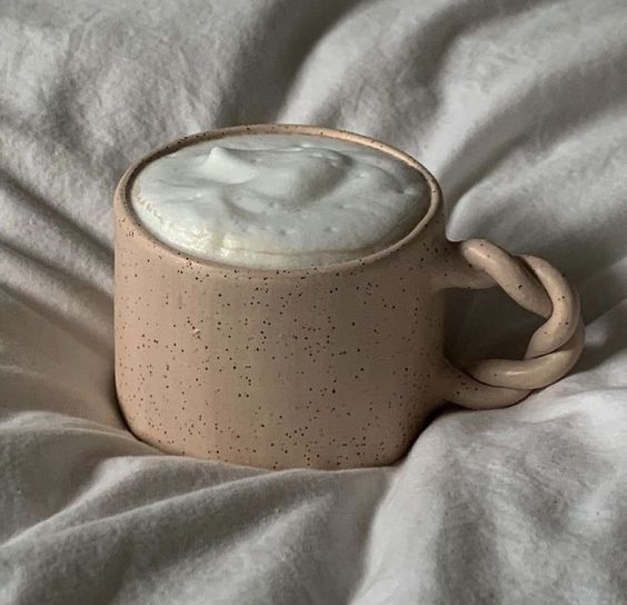 The Clay — A speckled mug resting on crumpled linen